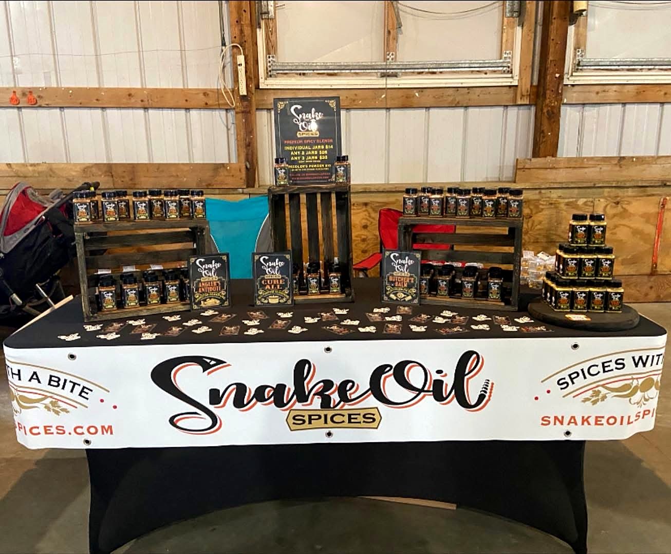 The Snake Oil Spices market table stacked with jars