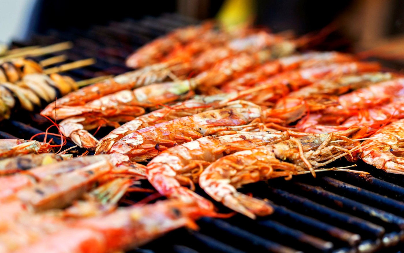 Prawns sizzling on a barbecue grill