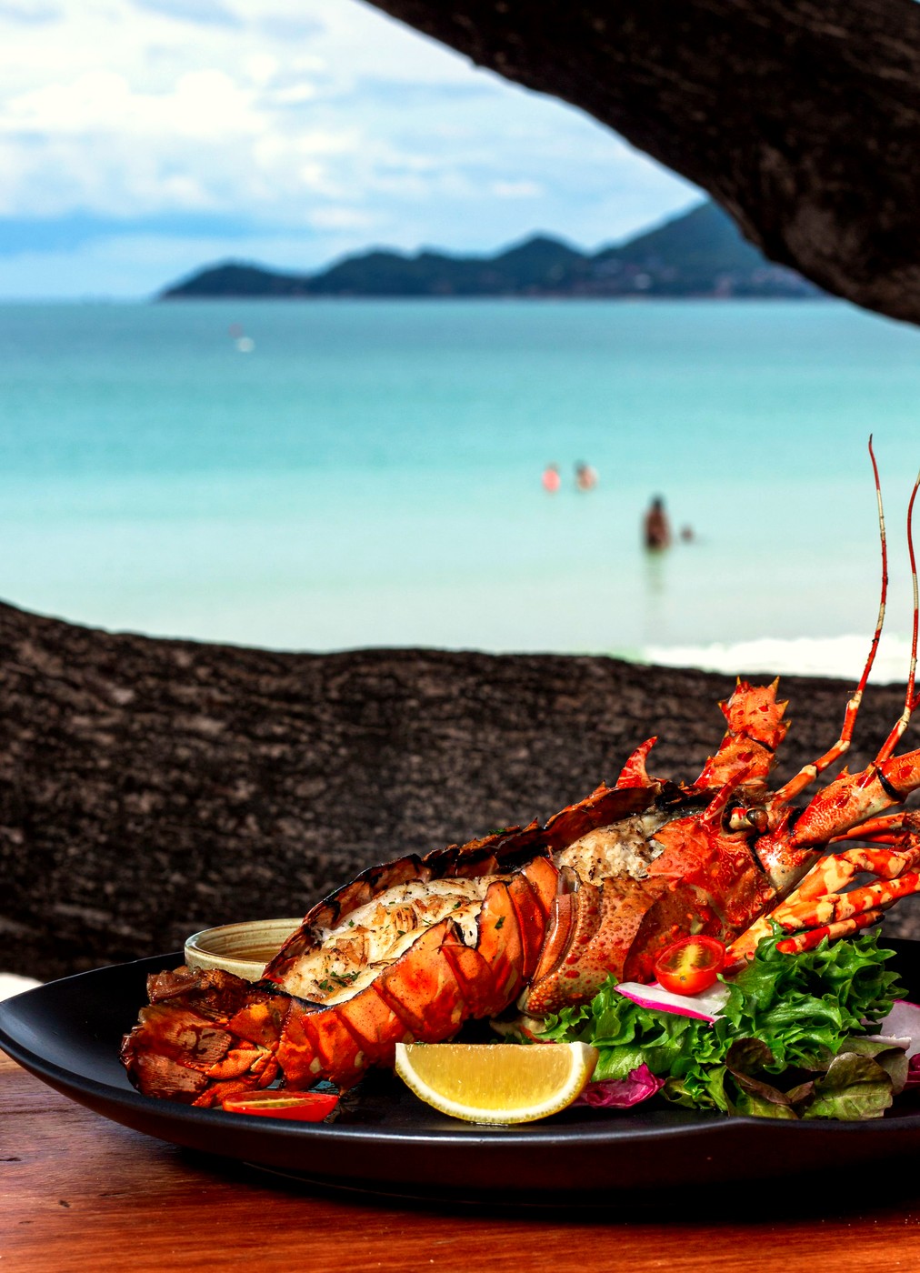 Grilled lobster plated with a beach view