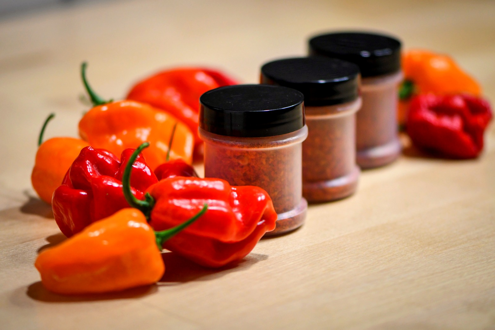 Snake Oil Spices jars with fresh peppers